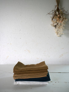 different colours of washed linen napkins with dry flowers at M AAH