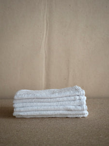pile of white waffle textured linen napkins at M AAH