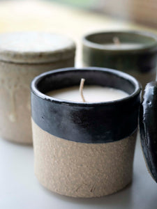 close-up of black ceramic scented candle with natural fragrances