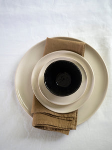 handmade black and white tableware with a French linen napkin