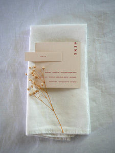 white linen napkin with personalised menu and dry flower for a wedding
