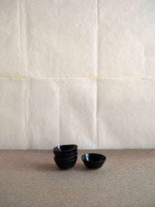 set of small ceramic bowls with a shiny black glaze