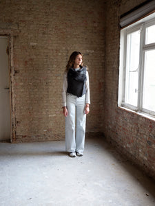 woman wearing a dark grey lamb skin jacket by atelier Les Henriettes