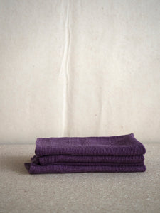 three purple linen napkins with waffle pattern by Linge Particulier
