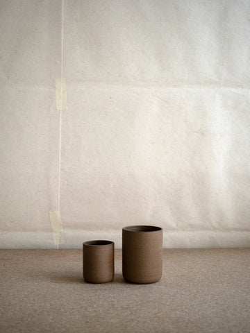 hand-thrown brown coffee cups by Inês Soares