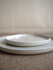 close-up of wheel thrown white stoneware plates