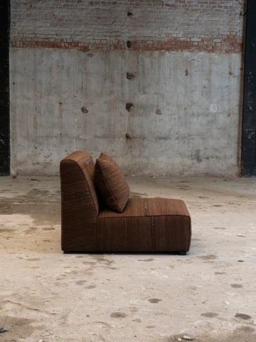 dark brown fauteuil covered with handwoven and vintage fabric by Marijke van Nunen