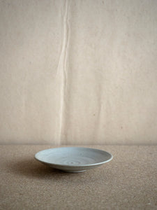 small handmade ceramic plate in light grey glaze at M AAH