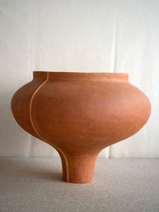 side view of ceramic sculpture in rust coloured ceramic clay