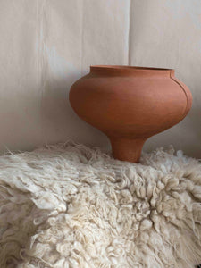 exclusive ceramic art sculpture and natural sheepskin rug