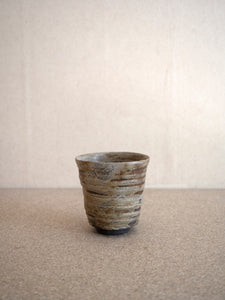unique and wood fired ceramic tea cup by Tomasz Niedziolka in grey green en brown colours