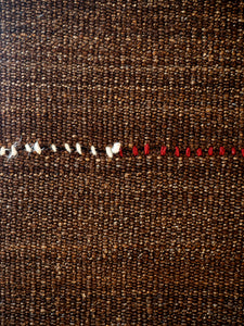 vintage kilim fabric in dark brown with red and white seam by Marijke van Nunen